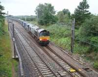 Having waited in Barton down goods loop for a Voyager to pass 66419 gets the Tesco containers under way again and draws forward onto the main line to continue its northwards journey. Originally there were four tracks from Preston to this point but they were reduced to two in the late 1960s, apart from an up loop just outside Preston and this one. <br><br>[Mark Bartlett 01/08/2009]