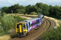 A Blackpool to York service climbs away from Farington Curve Jct and sweeps around the curve, before crossing the WCML and heading east through Lostock Hall on 1 August 2009. The Ormskirk line which also leaves the WCML at Farington Curve Jct is behind the camera to the right. <br><br>[John McIntyre 01/08/2009]