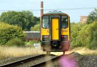 An Ormskirk to Preston service starts the descent to Farington Curve Jct. The Class 153 will pass under the road bridge seen on the left of the unit. The photo is taken from the site of the former junction which forked to the right and led to Lostock Hall.<br><br>[John McIntyre 01/08/2009]