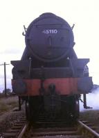 Another picture of <I>Black 5</I> 45110 in the exchange sidings at Ribbleton. The loco has brought in a load of coal for the Courtaulds plant [See image 24678] and is about to return to Lostock Hall. Note the hand painted smokebox number and also that the top lamp bracket has moved to the smokebox door due to overhead electrification safety concerns. 45110, in much cleaner condition, was to figure in the End of BR Steam workings before moving into preservation on the Severn Valley railway. <br><br>[David Hindle /07/1968]