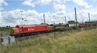 The Compass Railtours charter from Holyhead to Carlisle heads north at Euxton Junction on 2 August 2009 with the gaudy 37670 in DBS red leading the more sober 37401 in the former EWS maroon livery.<br><br>[John McIntyre 02/08/2009]