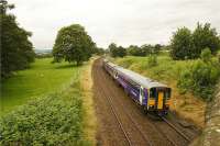 A Carlisle to Leeds service leaves Long Preston at 1342 hrs on its way to the next stop of Hellifield on 4 August 2009. The station can just be seen in the background in this shot from the A682 road bridge.<br><br>[John McIntyre 04/08/2009]