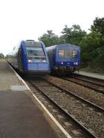 On time 18.49 departures from Velines; with modern Limoges based regional 2 car DMU on Bordeaux service arriving on left and local 2 car DMU on Bergerac service on right. <br><br>[David Pesterfield 13/07/2009]