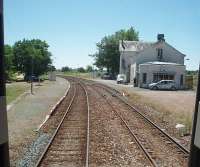 The stationmaster at St Server emerges to see the DMU for Angouleme pass through non-stop and join the single line towards Cognac that starts just beyond the station platforms. The main line to Bordeaux lies to the right of the station building. <br><br>[Mark Bartlett 23/06/2009]