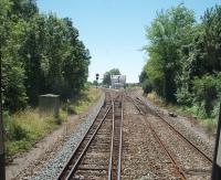 A DMU for Angouleme forks left at the triangular junction at St Server-de-Saintonge and joins the line running eastwards down the Charente valley to Cognac and Angouleme. The main line running south to Bordeaux is straight on at this point but only the Cognac line platforms remain at this little used country station that lies around 12km south east from Saintes. <br><br>[Mark Bartlett 23/06/2009]