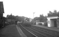 The Langholm/Newcastleton pickup freight from Kingmoor heading north at Penton station in August 1967 behind an EE Type 1. The train has an additional brake van in tow carrying a group of enthusiasts marking what was supposed to be the freight's final trip. As it transpired the service was reprieved a further twice due to complications with local coal contracts. [Thanks to Alasdair Taylor, John Robin and Ian Mackie] <br>
<br><br>[Bruce McCartney /08/1967]