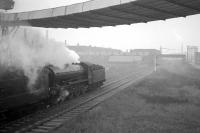 Having passed through the closed station of Haverton Hill, no 61418 is approaching Haverton Hill South Junction with the <i>Durham Rail Tour</i> of 13 October 1962. The train is on the return leg from Port Clarence and at this point is passing through a landscape dominated by various structures linked to the giant ICI Billingham complex. The train will continue to North Shore Junction (a link closed in 1974) in order to reach Stockton station.<br><br>[K A Gray 13/10/1962]