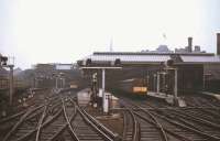 View from the window of a railtour approaching Newcastle Central in May 1967 as the light begins to fade. One of the North Tyneside third-rail DC electric services stands in the bay, destination <i>'Coast'</i>, shortly before the line was de-electrified and DMUs took over these operations. The North Tyneside line was, of course, subsequently re-electrified in the early 1980s and is now part of the Tyne & Wear Metro system.<br>
<br><br>[Colin Miller /05/1967]