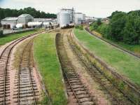 View west over the platforms at Cameron Bridge in 1993. Following major expansion at the Diageo complex in the background, coupled with a number of recent transport studies, the line from Thornton to Leven has become a strong candidate for reopening to both passenger and freight services. <br><br>[Ken Browne //1993]