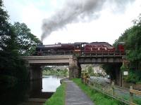 Jubilee 4-6-0 <I>Leander</I> slowly climbs the bank south of Lancaster station and crosses the Lancaster Canal at the start of another <I>Fellsman</I> excursion to Carlisle via Preston, Hellifield and the S&C. <br><br>[Mark Bartlett 12/08/2009]