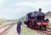 Scene at Aviemore Speyside in 1979. Neil Clark acting as fireman clutching the token, with the Ivatt about to return to Boat.<br><br>[Colin Miller //1979]