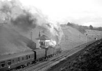 B1 no 61349 climbs away from Tynehead station and past the signal box with a southbound train in April 1964, complete with a horse box marshalled next to the locomotive.<br><br>[Robin Barbour Collection (Courtesy Bruce McCartney) /04/1964]