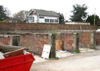 Once a common site in station yards across the land -  the former coal drops at Strensall on the York - Scarborough line, seen here in April 2009. The signal box stands on the south side of the line beyond the wall, with the raised crossing barriers to the right. The old station (closed 1930) is on the other side of the crossing. The remains of the yard have been put to use by a local building firm.  <br>
<br><br>[John Furnevel 19/04/2009]