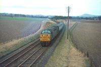 A southbound train on the Waverley route hauled by an EE Type 4 photographed in December 1967. The train has just passed Kelso Junction where a freight can be seen held on the branch line in the background.<br>
<br><br>[Bruce McCartney /12/1967]