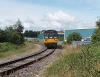 I could hear the train's crew changing the points with the groundframe at the junction [See image 18114] before 142091 appeared on the Heysham branch with the daily boat train for the port. The Arriva liveried Pacer is just passing the point of the old junction for the direct line to Lancaster Green Ayre and about to pass the public cycle path crossing from where this picture was taken. <br><br>[Mark Bartlett 13/08/2009]