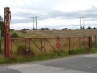 Level crossing gate on Whinney Lane to the west of Streethouse station on the abandoned branch to Sharlston Colliery (closed 1993). The connection to the Pontefract - Wakefield line was approximately 100m to the left of the crossing.<br><br>[David Pesterfield 14/08/2009]