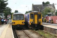 Rush hour (or at least 1242 hrs) at Bare Lane as the Leeds to Heysham Harbour (ignore the destination display) with 144010 in charge passes 156486 on a Morecambe to Lancaster service.<br><br>[John McIntyre 11/08/2009]