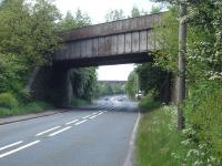 The Crigglestone Junction to Horbury Bridge branch overbridge crossing Denby Dale Road at Calder Grove, immediately after Crigglestone junction, with the Thornhill to Notton line viaduct in distance. The latter crossed the British Oak disposal point's canal coal staith spur and exchange sidings, Denby Dale Road, and the Horbury Junction to Barnsley line. Standing at the crossroads in the centre of the picture there is a rail overbridge visible a short distance along all four roads.<br><br>[David Pesterfield 20/05/2009]