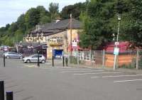 The former station building at Bearsden (opened 1863) - now houses a stylish pub/restaurant known as <i>The Inn</i>. Photographed on 8 August 2009, with its modern day replacement standing alongside on the right and the platform entrance between the two.<br><br>[David Panton 08/08/2009]