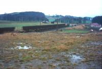 A wet and miserable day in 1971, as an EE Type 4 with a  Waverley track recovery train passes the playing fields on the edge of Burnfoot on its way north out of Hawick.<br>
<br><br>[Bruce McCartney //1971]