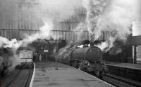B1 4-6-0 no 61173 is about to take a train out of Bradford Exchange in the 1960s. The station, built as a joint project by the Lancashire & Yorkshire and Great Northern Railway, effectively operated as two separate stations for much of its life. Modelled on London Kings Cross, it had two 450ft long arched roofs, with each company operating five platforms and separate booking offices, an arrangement that lasted until early 1940. The station eventually closed in 1973 with trains operating from a much simplified station located 185m further south behind the camera. The old Exchange station building was eventually demolished in 1976 and its 1973 replacement was renamed Bradford Interchange in 1983.<br><br>[Robin Barbour Collection (Courtesy Bruce McCartney) //]