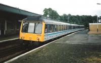 From the days when there was only one station in Dunfermline a largely empty 117 310 heads for Edinburgh with the returning 1638 Inner Circle, a pretty sure 117 diagram at a period when they were only used at peak hours to supplement the 150s.All those doors made for quick loading and emptying, accompanied by a burst of door slamming like machine gun fire.The downside of lots of doors was that they had to be placed between facing seats, so anyone still sitting who had feet bigger than size 4 invariably got them trodden on.Photographed in June 1997. <br>
<br><br>[David Panton /06/1997]