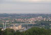A view of Carlisle Bridge at Lancaster, taken from alongside the Ashton Memorial in Williamson Park. The River Lune, Morecambe behind and finally a murky Morecambe Bay can all be seen and the sharp eyed will spot 5690 <I>Leander</I> coasting into Lancaster (Castle) station with the ECS of the <I>Fellsman</I> train. <br><br>[Mark Bartlett 19/08/2009]