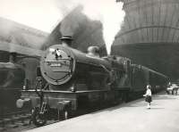 <I>Happy Birthday...  I got you a nice lump of coal...</I> This photograph, featuring Midland compound 1069 at St Enoch, thought to date from around 1936, was taken as an intended publicity shot, hence the young lady posed in the picture. However it was not used and subsequently lay in a file until rediscovered around 1972. You can also make out a Manson 0-6-0 in the background, presumably on station pilot duty.<br>
<br><br>[Ken Browne Collection //1936]