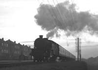 A Gourock to Glasgow semi-fast hauled by a Fairburn 2-6-4T photographed at Hillington East one evening in May 1963.<br><br>[Colin Miller /05/1963]