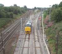 Direct Rail Services Class 37 No. 37194, on a test run, rejoins the East Lancashire line at Farington Curve Junction while on a test run from the West Coast Railway depot at Carnforth where it had recently been overhauled. The loco had reversed in Preston and provided an unusual sight as DRS locomotives are rarely seen on the Preston to Blackburn line.<br><br>[Mark Bartlett 25/08/2009]