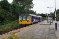 The last stop (for some services at least) before arriving at Southport on the line across West Lancashire from Wigan Wallgate is Meols Cop. The facilities are basic at this island platform with a small shelter and access is via a set of steps down from cross roads above. On 26 August 2009 142012 slows, not to stop here but to negotiate the severe curve just beyond the station which has a 20 mph psr.<br><br>[John McIntyre 26/08/2009]