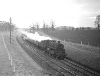BR Standard class 4 2-6-0 no 76050 heading north with the noon Hawick - Edinburgh train approaching Kelso Junction in November 1963. The train has just passed the home signal for the junction and the distant for St Boswells South.<br>
<br><br>[Robin Barbour Collection (Courtesy Bruce McCartney) 09/11/1963]