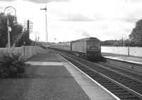 A northbound <I>Motorail</I> service passes through Carluke behind a Brush Type 4 locomotive in July 1965.<br><br>[Colin Miller /07/1965]