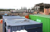 Out with the old...  the 1124 Bathgate - Edinburgh train passes the former Bathgate locomotive shed on 28 August 2009. Demolition work on the old shed is well underway.<br>
<br><br>[John Furnevel 28/08/2009]