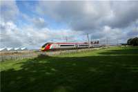 A southbound Pendolino catches the morning sun as it speeds by the extensive truck factory site on the west side of the WCML south of Farington Junction on 29 August 2009.<br><br>[John McIntyre 29/08/2009]