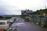 The final station on the L&SWR route to Cornwall was the fishing town of Padstow on the River Camel. The town lost the former L&SWR connection in October 1966, however services did continue until the end of January 1967 from Bodmin. The photo (looking east towards Wadebridge) shows the station building and platform only 30 months after services had finished. The trackbed has already taken over as a car park and the station building looks like it has been taken over by the local bus company. On the extreme left of the photo is the fish shed where refrigerated railway wagons were loaded up to be taken to fish markets in the south of England.<br><br>[John McIntyre /07/1969]