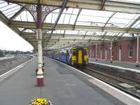 Kilmarnock station has always had, for me, a slightly melancholy air as if we were still in the immediate post-Beeching era and the service was almost skeleton [see image 22787]. Things are a little less quiet now and will become even less so come December when the service to Glasgow will double to half-hourly.The roundels in the canopy brackets contain the letters 'G&SWR Co' but are so ornate you can be forgiven if this is not immediately obvious - it wasn't to me until reviewing this picture and I've visited the station over many years. On 2 September 156 494 waits at Platform 2 with a train on the generally lightly-used <I>Burns Line</I> with a service for Girvan. <br>
<br><br>[David Panton 02/09/2009]