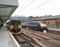 As 91110 arrives at Wakefield Westgate in the Down platform 155346, newly arrived from Selby, waits on the Up side to shunt into the turnback siding clearing the platform for another service. The Leyland built DMU is one of seven West Yorkshire two-car sets  that were never converted into Class 153 single car units.<br><br>[Mark Bartlett 04/09/2009]