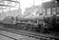 Royal Scot 4-6-0 no 46152 <I>The King's Dragoon Guardsman</I> stands at Carlisle on 23 January 1965. The locomotive has recently arrived light engine from Kingmoor shed and will shortly take over the 9.25am Crewe - Perth. For a photograph of locomotive and train passing Kingmoor [see image 40253].<br><br>[Robin Barbour Collection (Courtesy Bruce McCartney) 23/01/1965]