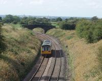 Preston can be seen on the skyline as 142041 passes Hoghton summit, although it is still eight miles away. Immediately around this bend the unit will pass over the level crossing that marks the site of Hoghton station, closed in 1960.<br><br>[Mark Bartlett 07/09/2009]