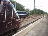 A classy looking Cross Country HST power car, 43366, is on the rear of a Penzance service at Wakefield as 91129 heads north on a Kings Cross to Leeds service. Just beyond the platforms is a turnback siding where DMUs can clear the mainline between services.<br><br>[Mark Bartlett 04/09/2009]