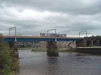 Scale Hall was a modern but short lived station on the electrified Lancaster Green Ayre to Morecambe direct route, opening as late as 1957 but closing with the line in 1966. It was constructed of prefabricated concrete sections but most traces have been swept away. This view of Carlisle Bridge at Lancaster was taken just to the east end of the old station site from the cycle way that runs along the old line. 144002 is heading for Morecambe and Heysham Port crossing an incoming tide on the Lune Estuary. <br><br>[Mark Bartlett 08/09/2009]