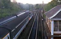 A 477 turns the sky blue one late summer evening as it leaves Dunblane heading north. A DMU to the left lies over before returning south and a tamper shelters in the cut back Callander and Oban line. The box has since been re-painted white.<br><br>[Ewan Crawford //1989]