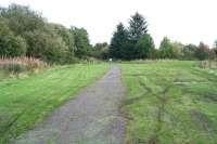 View east along the trackbed towards Bridge Street over the site of the former Fauldhouse & Crofthead station in September 2009. Originally opened by the Wilsontown, Morningside & Coltness Railway in 1848 as Crofthead, the station, which had a single platform on the north (left) side, eventually closed to passengers in 1930. The line remained open east of here for freight, including a branch south to the nearby Levenseat quarry and works, until well into the 1960s, eventually being cut back to Polkemmet Junction in 1969.<br>
<br><br>[John Furnevel 15/09/2009]