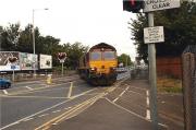 The morning rush hour traffic is brought to a stand on Strand Road, Preston as 66181 hauls 8 empty bogie tank wagons from the tar distillery at Preston Docks bound for the Lindsey oil terminal on 16 September 2009. Beyond the level crossing the line climbs quickly between the houses on Fishergate Hill before joining the main line at the south end of Preston station.<br><br>[John McIntyre 16/09/2009]