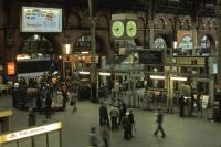 Compared to its bright, present day appearance, Liverpool Street station looked every bit its age in the late 1970s, even on a summer's evening, as pictured here. Electronic departure boards were still in their infancy - the rather scruffy <I>manual</I> boards with each train's details can be seen stacked at the heads of the platforms. Just visible at platform 12 is a Class 309 EMU that will soon depart for Clacton and Walton.<br><br>[Mark Dufton 02/07/1978]