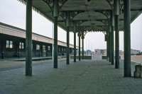 The Eastern & Midland Railway logo cast into the canopy spandrels is the giveaway to this location being the former Midland & Great Northern terminus at Yarmouth. The station did not really close to passengers in 1959 - it merely swapped trains for buses and carried on as a coach station until final demolition in 1986. This photo shows the deserted coach station in October 1977 and illustrates perfectly the reason for the railway's closure. Whereas the station was a hive of activity on summer Saturdays as holiday makers came and went, out of season there was very little passenger traffic.<br><br>[Mark Dufton 30/10/1977]