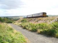 Shortly after leaving Fauldhouse station on 15 September 2009 an Edinburgh bound service turns south east to run onto the viaduct spanning the northern section of Greenburn golf course. In the foreground, running parallel with the ex-Caledonian line at this point, is the trackbed of the long closed freight only branch running south from Fauldhouse Moor which turned east in the middle distance to join the Wilsontown, Morningside and Coltness line on the approach to the former Fauldhouse & Crofthead station. [See image 25447]    <br>
<br><br>[John Furnevel 15/09/2009]