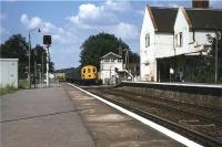 3 car DEMU no 1128 passes the signalbox as it approaches Dunbridge station with a southbound service from Salisbury in the summer of 1985.<br><br>[John McIntyre //1985]