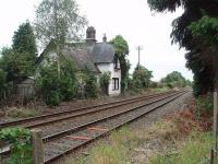 Whittington Low Level station, on the Chester to Shrewsbury route, closed in 1960. Despite a number of vigorous local campaigns it has never reopened but the station building survives as a private residence. The High Level station was on the Cambrian route to Oswestry that crossed this line at right angles. This view is south towards Shrewsbury from the level crossing. <br><br>[Mark Bartlett 17/09/2009]